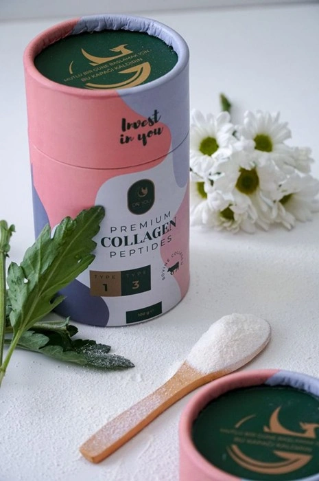 Premium collagen peptides powder tin with a wooden spoon, for women's daily drink routine