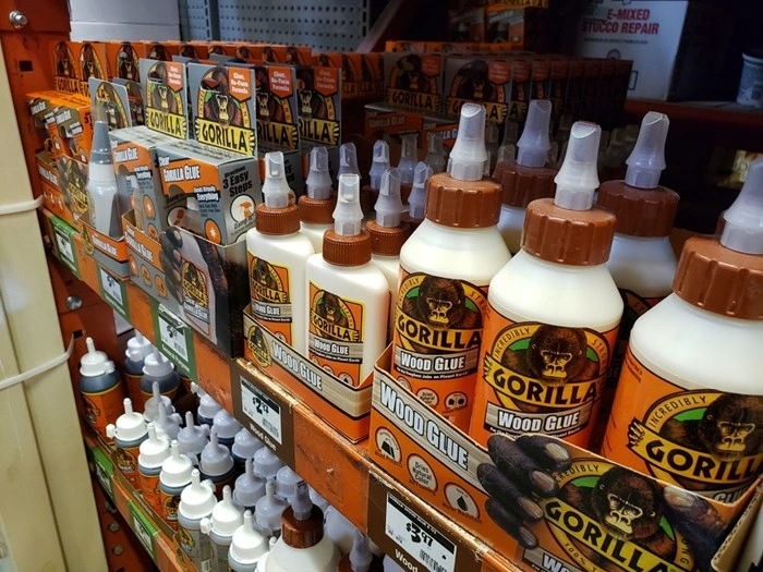 Gorilla Glue and wood glue tape products displayed on hardware store shelf