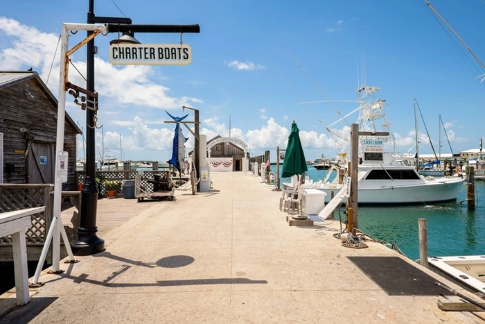 Charter boats dock in Key West with fishing boats lined up at the pier