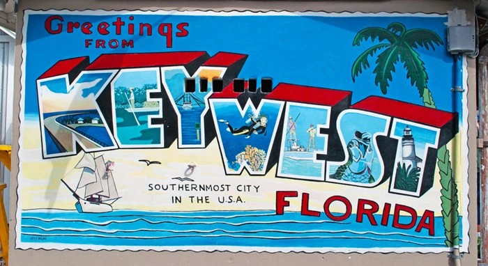 Greetings from Key West Florida mural featuring sailboats, diving, and landmarks