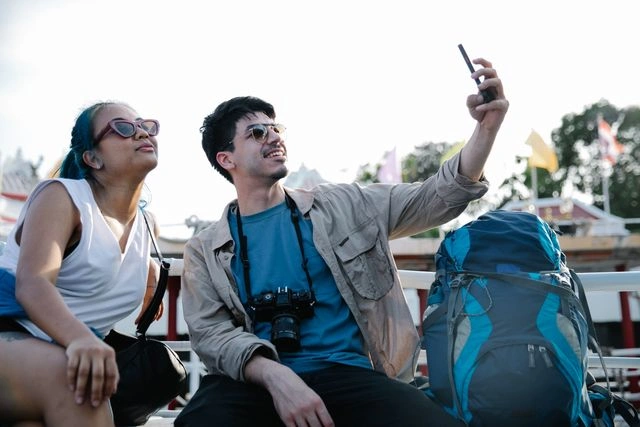 Travelers Taking a Selfie Together and Making Friends on a Group Tour