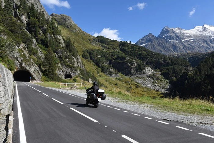 Motorcyclist riding through Susten Pass in the Swiss Alps