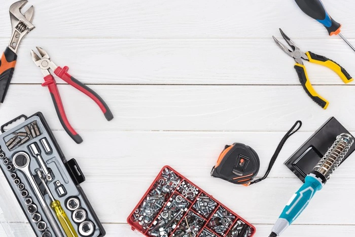 Emergency repair toolkit with wrench, pliers, sockets, and tape measure