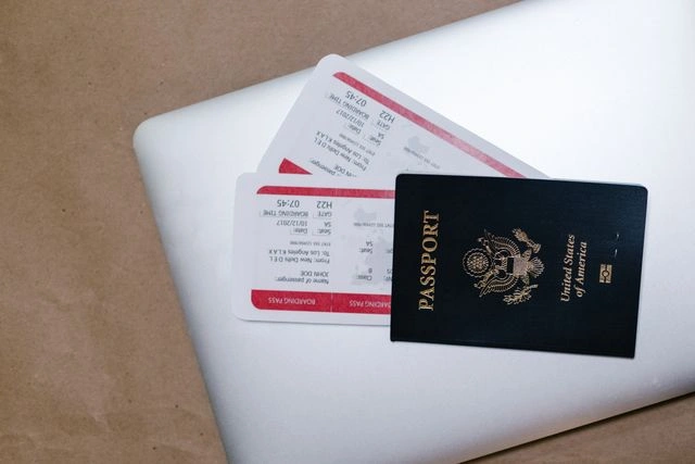 Passport and Boarding Passes on a Laptop for Guided Holiday Travel Planning
