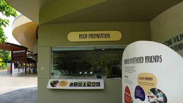 The food preparation viewing window at Bird Paradise, with an information board about caring for the birds, where kids can see how keepers prepare meals for the park's residents