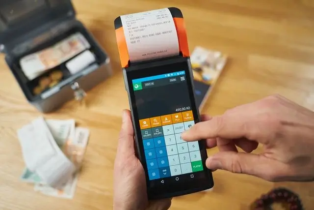 Mobile invoicing for contractors on a handheld device that prints receipts on the spot, next to an open cash box