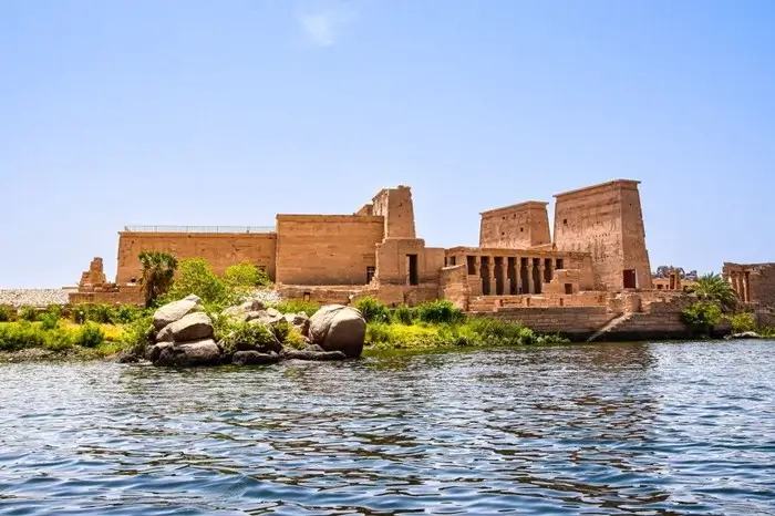 Philae Temple on Agilkia Island seen from the Nile in Aswan, with its sandstone pylons rising above the water