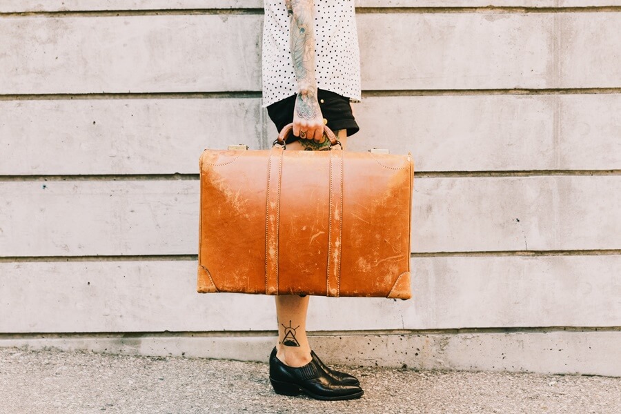 woman holding her suitcase to travel. 