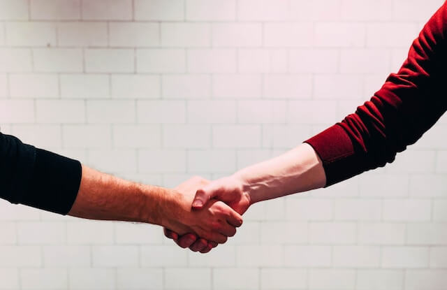 people shaking hands for a business deal. 