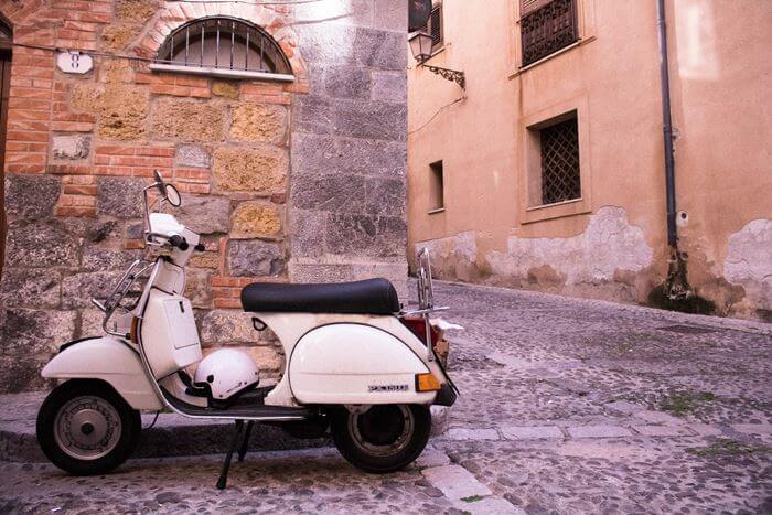 a scooter on a cobbled street in Sicily, Italy. 