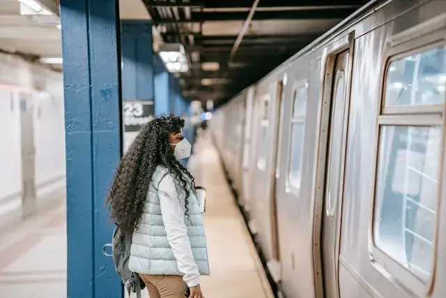 a student traveling, waiting for a metro.