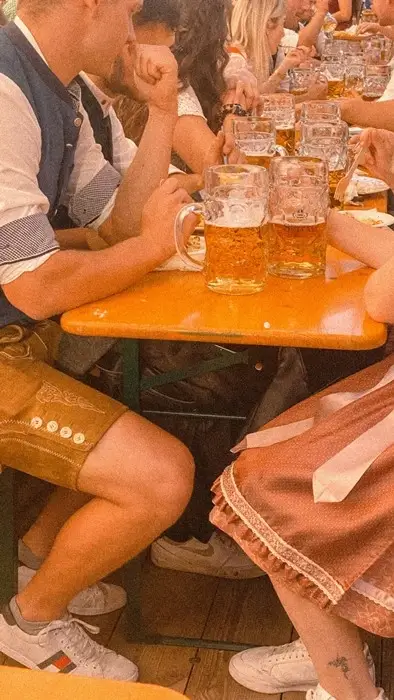 Men and women wearing lederhosen and dirndls, the traditional Bavarian clothings.