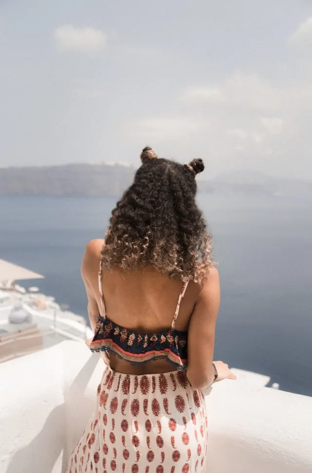 a lady with hairstyle in Santorini, Greece.