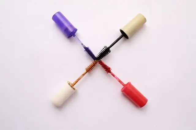 Colorful mascara collection featuring purple, black, brown, and coral lash growth formulas