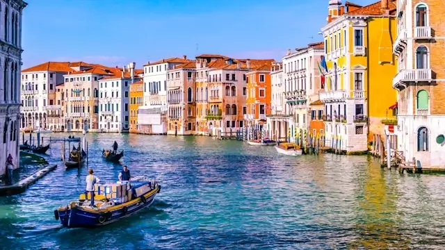Venice Grand Canal with vibrant palazzos and gondolas during golden hour
