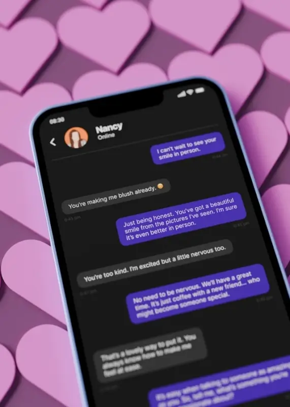 Smartphone displaying dating app conversation with flirtatious messages on pink heart background illustrating online romance scam tactics