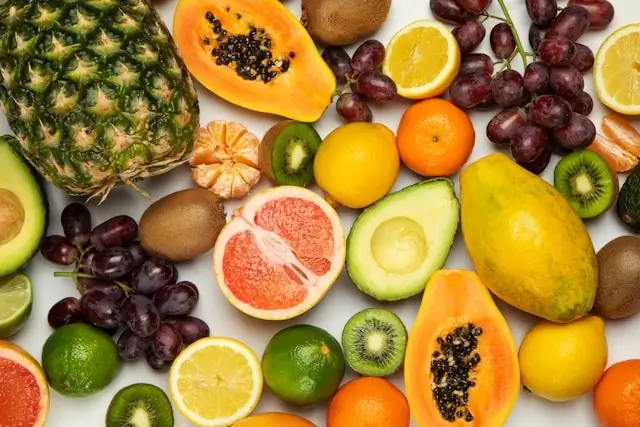 Colorful antioxidant-rich fruits including papaya, avocado, citrus supporting healthy skin tips diet