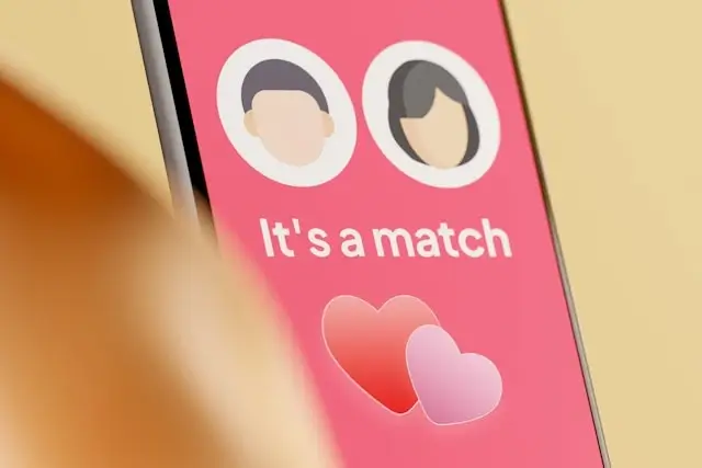 Dating app match notification screen showing two profile avatars with hearts, representing online dating platforms used in romance scams