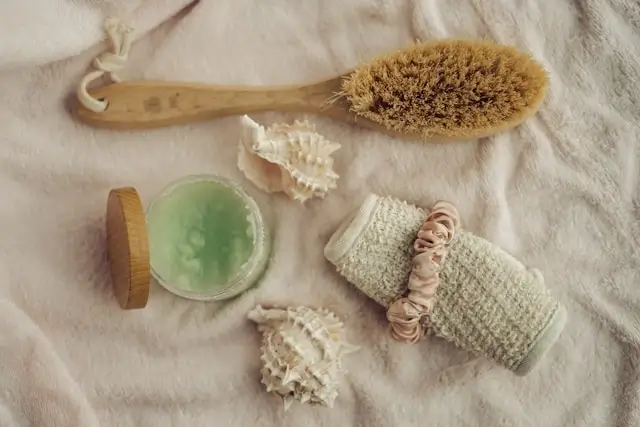 Natural skincare tools including dry brush, soap, loofahs for gentle healthy skin tips routine