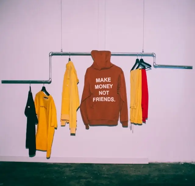 Colorful clothing rack with hoodies and shirts - organizing preppy travel essentials for efficient packing selection