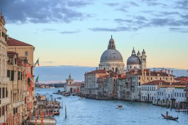 Venice Grand Canal at sunset with Santa Maria della Salute basilica and traditional gondolas