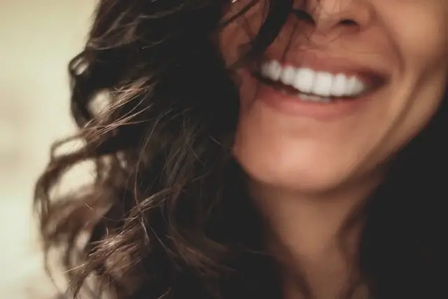 Woman with healthy white teeth smiling, showing good oral health and dental care results
