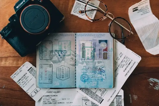 Travel documents with passport stamps and boarding passes for budget travel planning