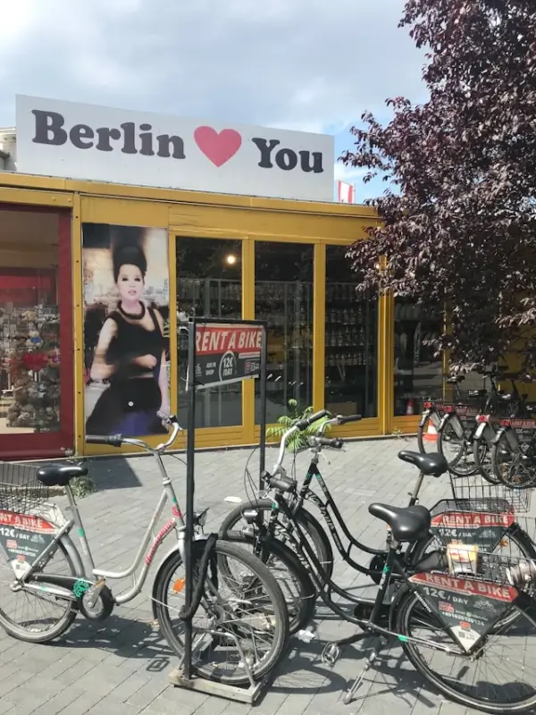 Bike rental shop with parked bicycles on Berlin street showing rent a bike sign in Germany