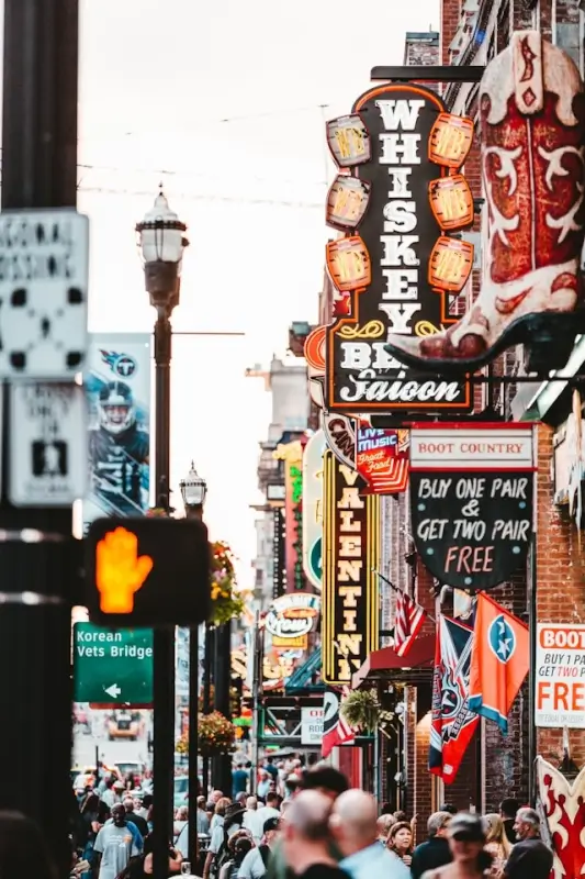 Nashville Broadway street filled with neon honky-tonk bar signs and crowds ideal for bachelorette party nightlife