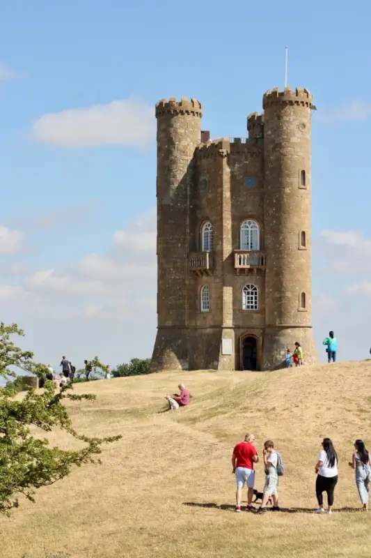 Historic Cotswolds castle tower attracting tourists and families visiting popular Cotswolds tourism attractions and landmarks