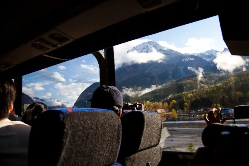 Passengers enjoying scenic mountain views from comfortable bus seats during ottawa to montreal by bus journey through Canadian landscape