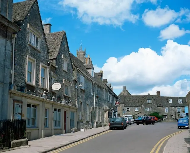 Cotswolds market town high street with Georgian limestone buildings popular with Cotswolds tourism visitors and holiday rental guests