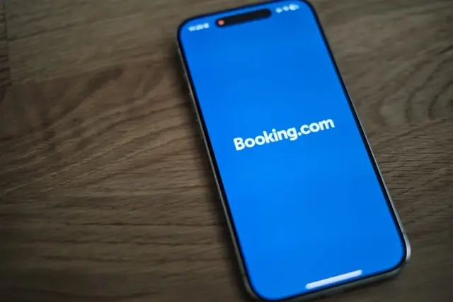 Mobile phone showing Booking.com app for flexible travel booking and last-minute accommodation reservations