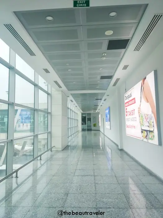 Modern corridor inside Sarpi border terminal with exit signs during Turkey-Georgia border crossing process
