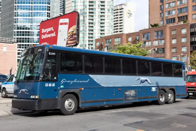 Greyhound bus parked at urban terminal station for ottawa to montreal by bus service in downtown Canadian city