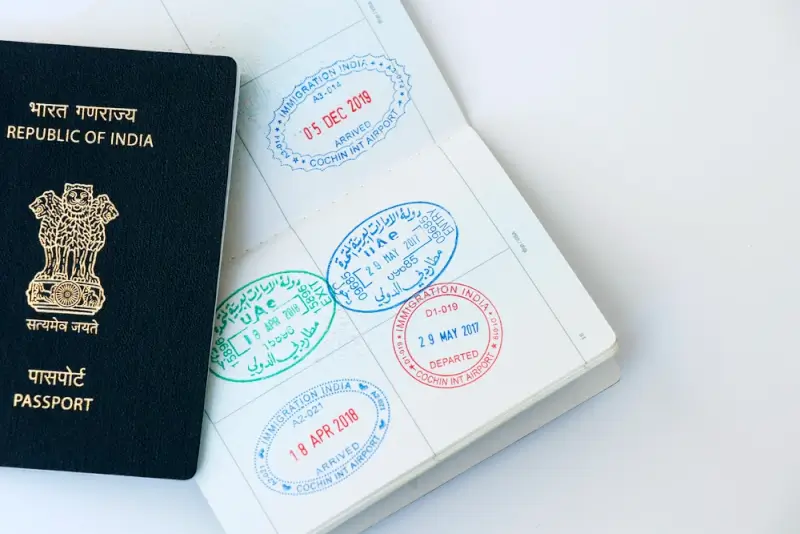 Indian passport with multiple visa stamps and immigration entry stamps for international travel as a part of Japan visa requirements for Indian citizens.