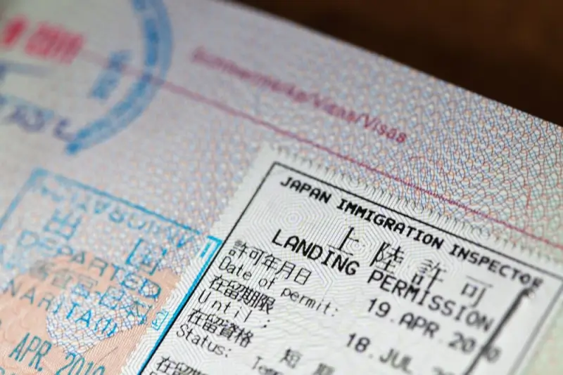 apan Immigration Inspector landing permission stamp with entry dates in passport showing arrival documentation on an Indian passport