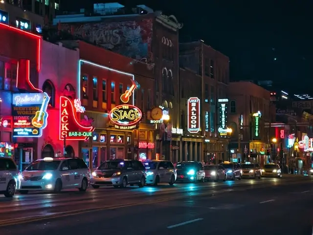 Nashville Broadway at night with glowing neon signs from honky-tonk bars perfect for bachelorette party nightlife crawls