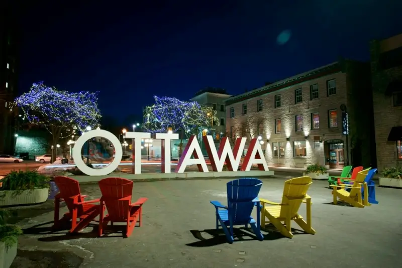 Ottawa city sign at night showing departure point for ottawa to montreal by bus travelers in Canada's capital