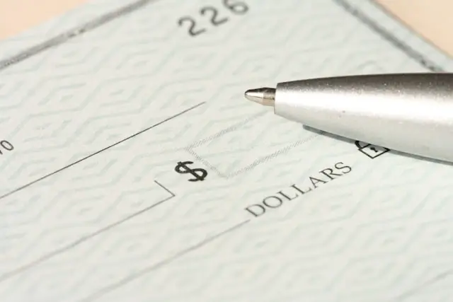 Paycheck with pen showing dollar amount highlighting accurate payroll processing and employee compensation