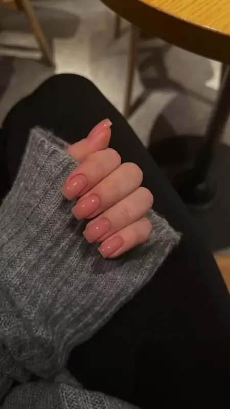 Long glossy pink gel nails with square shape showcasing professional nail treatment results