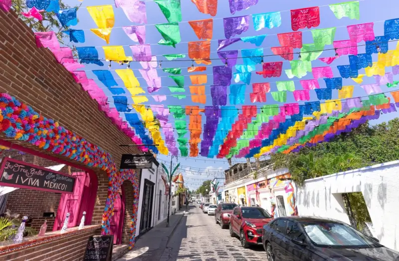 Colorful papel picado decorations over historic street in San José del Cabo art district near Palmilla