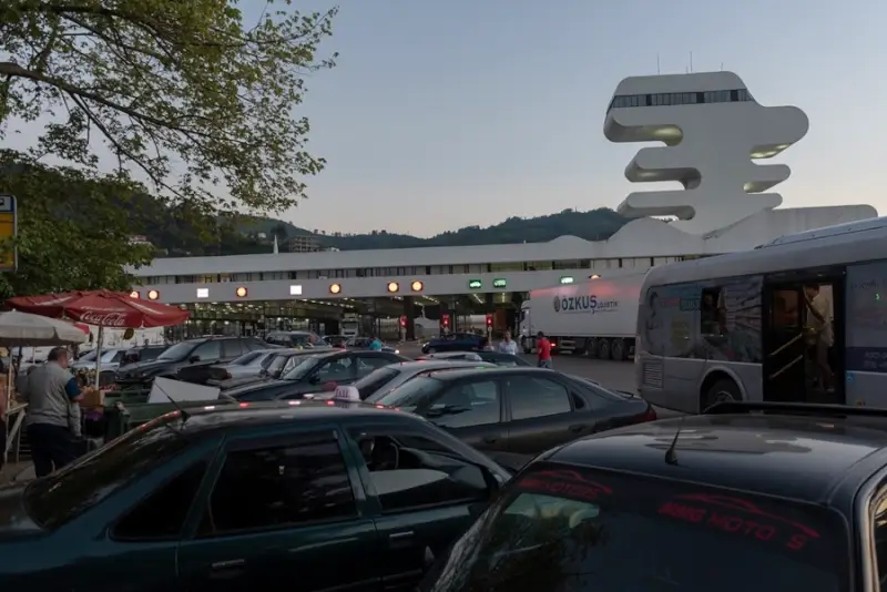 Sarpi border crossing facility with cars and buses waiting for Türkiye-Georgia immigration processing at evening time
