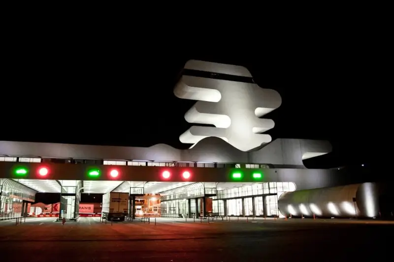 Sarpi border crossing terminal building illuminated at night with green and red lights for Turkey-Georgia border control