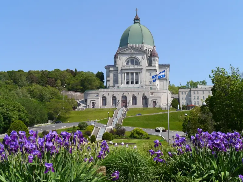 Saint Joseph's Oratory Montreal landmark destination reached by ottawa to montreal by bus with Quebec flag and spring flowers