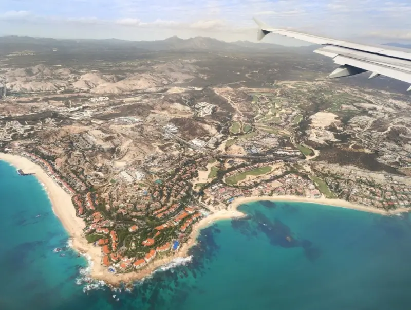 Aerial view of Palmilla Los Cabos coastline showing luxury resorts, golf courses and turquoise beaches