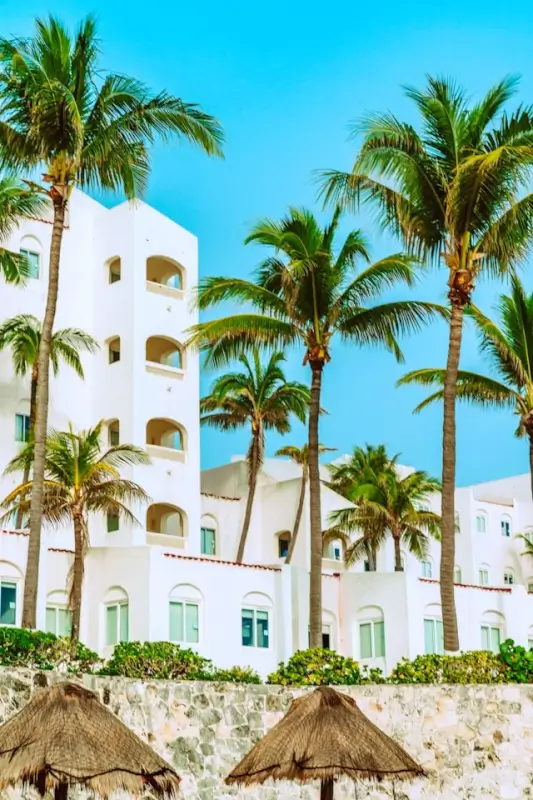 Traditional timeshare resort with white buildings and palm trees representing fixed vacation ownership model