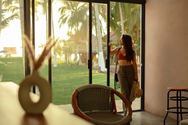 Woman enjoying spontaneous tropical getaway from modern vacation rental with ocean view and flexible booking