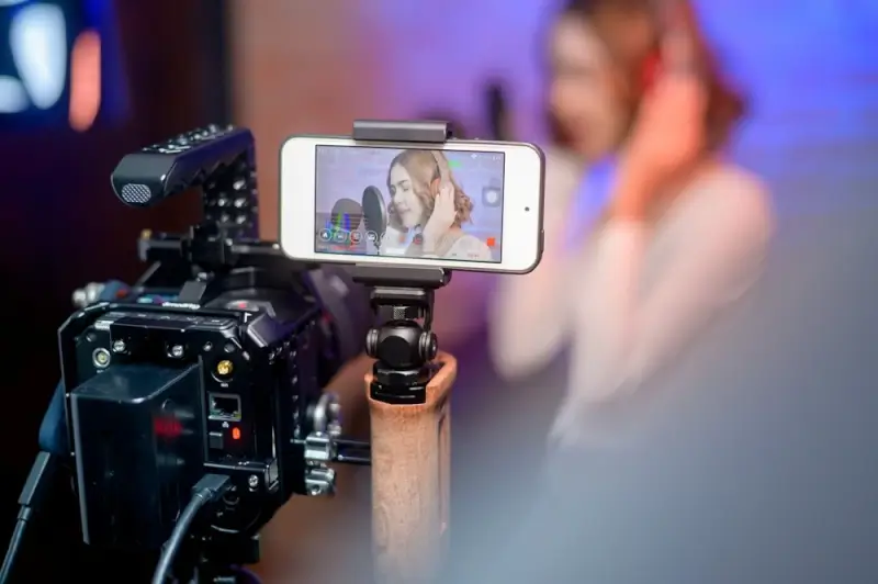 Professional vlogging setup with smartphone on gimbal and external microphone - hybrid filming equipment for content creators