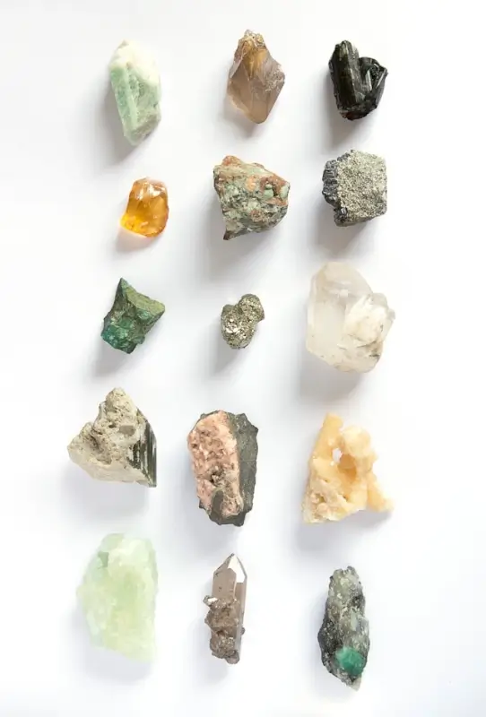 Collection of raw natural crystals and minerals in various colors showing authentic geological formations, inclusions, and rough cuts for crystal identification guide